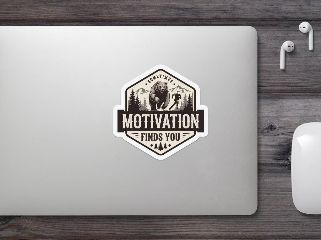 Hexagonal sticker with bear and runner illustration, reading "Sometimes Motivation Finds You".