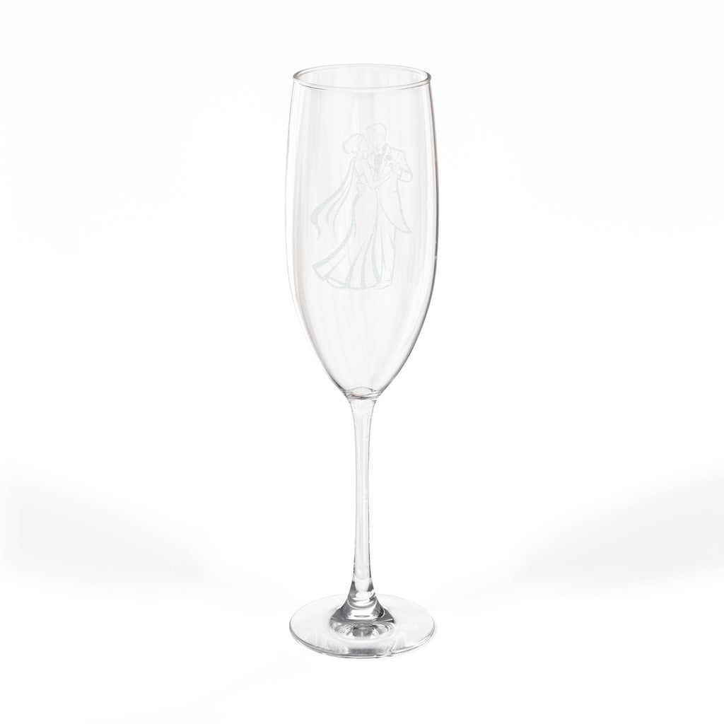 Champagne flute with etched wedding couple illustration on white background.