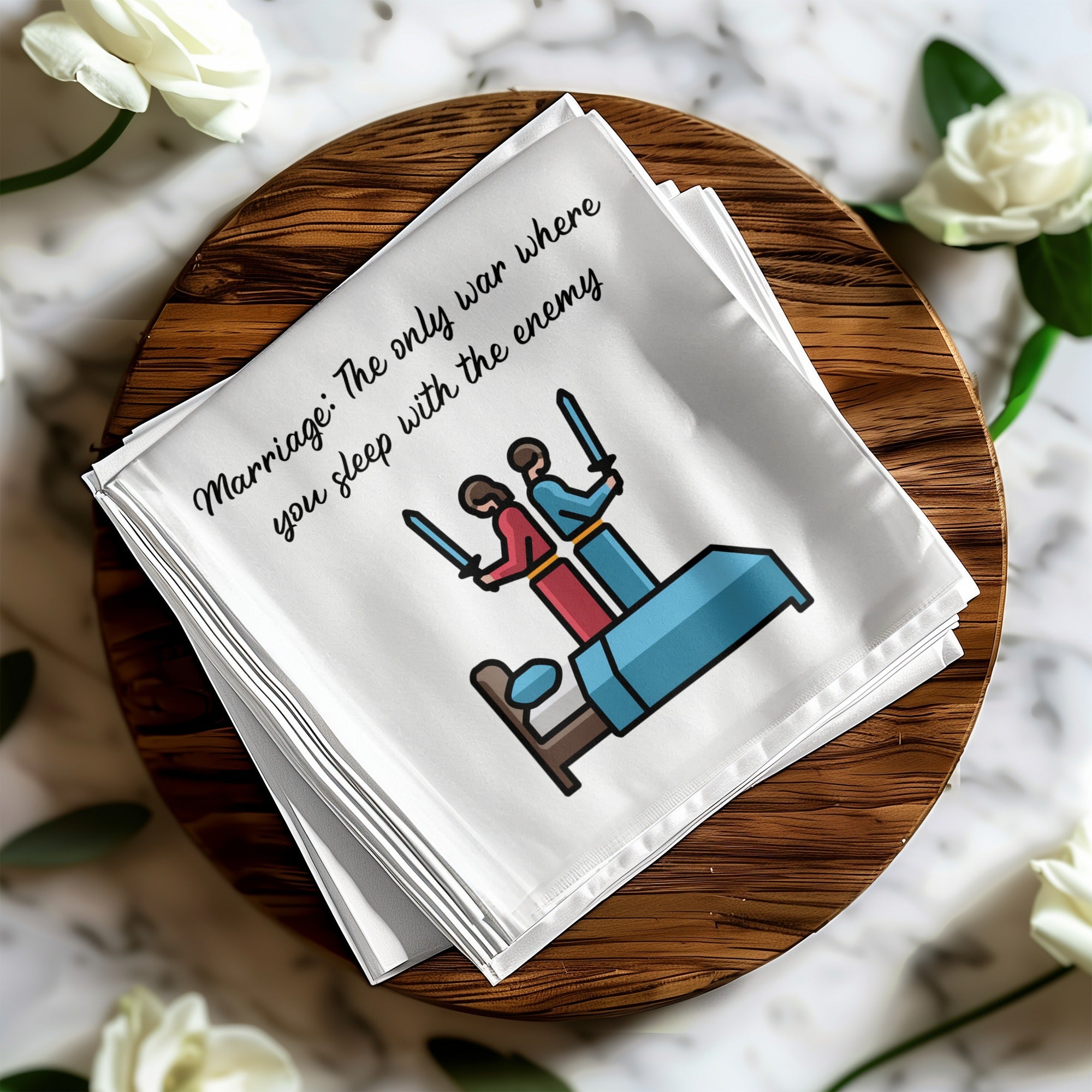 Napkin with illustration of a couple in bed with swords, text: Marriage: The only war where you sleep with the enemy.