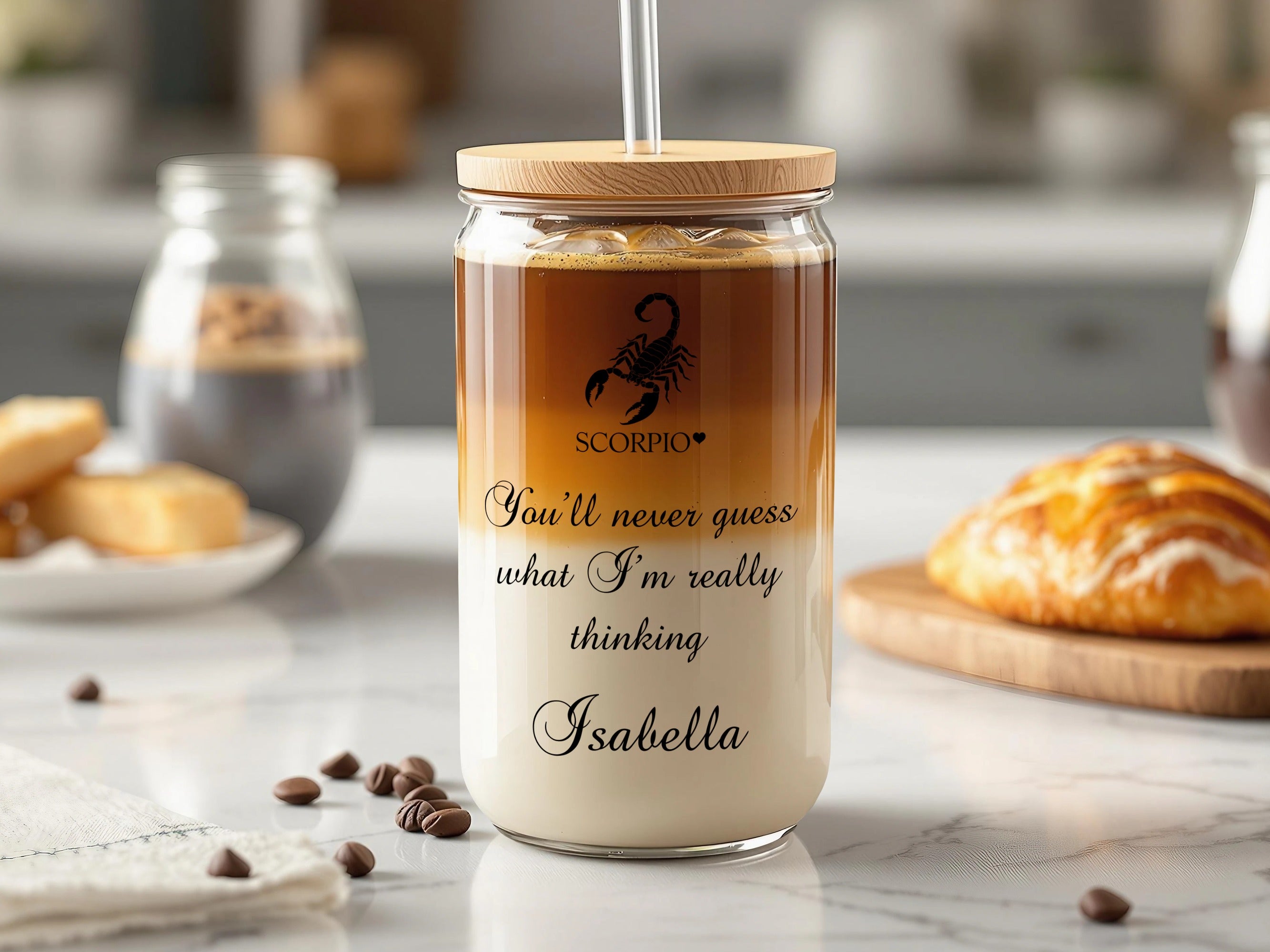 Glass tumbler with scorpion logo, "You'll never guess what I'm thinking Isabella" text, and straw.