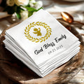 White linen napkins with "God Bless Emily" and a golden angel with wings.