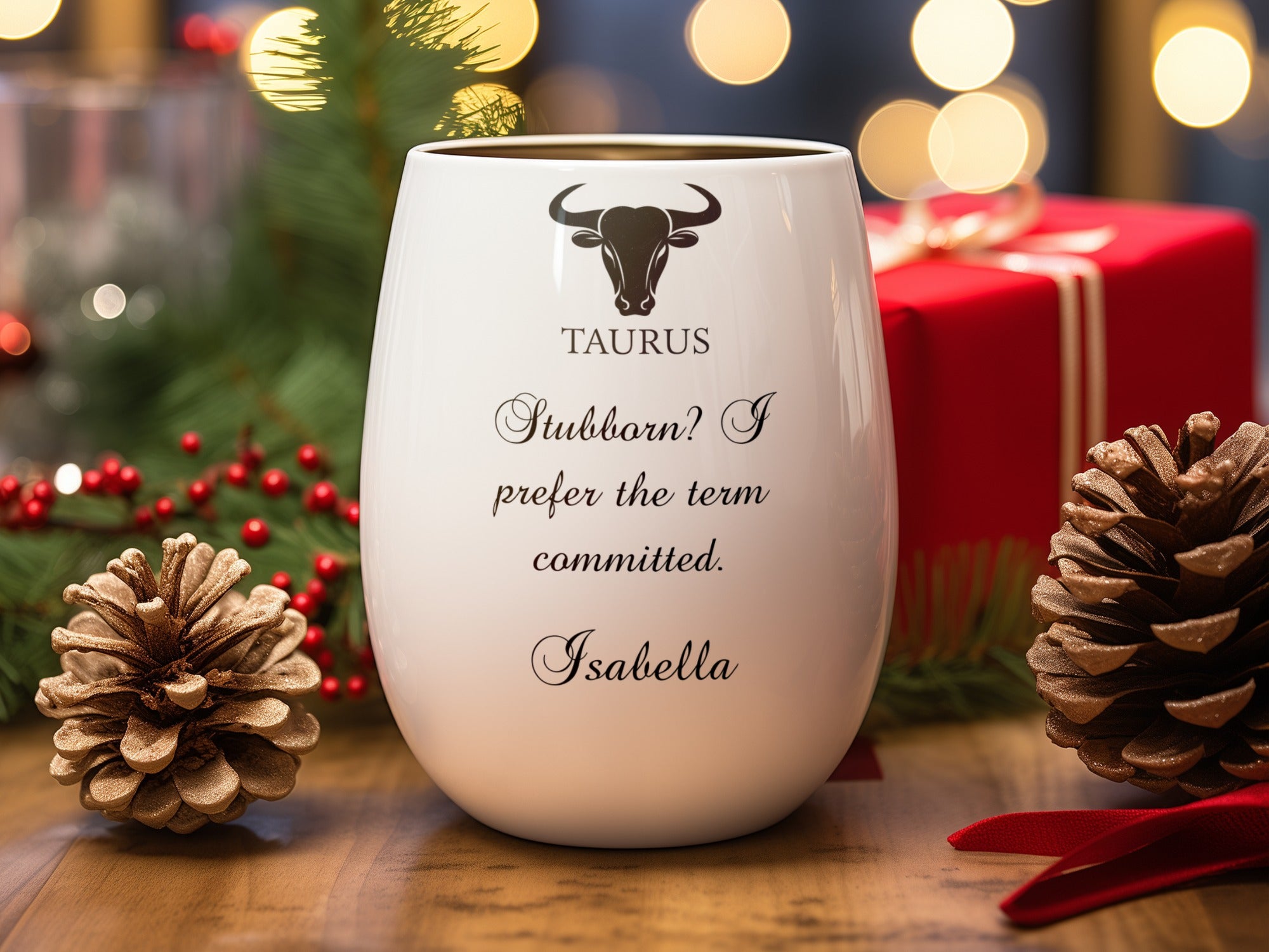 White goblet with "TAURUS Stubborn? I prefer the term. Isabella" text and a bull symbol.