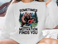 Bear chasing man with text "Sometimes Motivation Finds You".