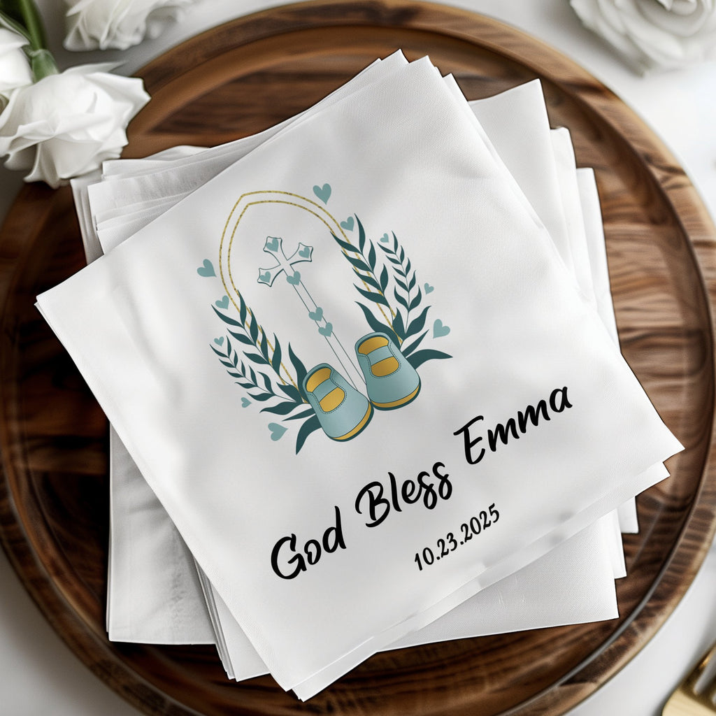 God Bless Emma baptismal napkins with baby shoes and cross design, dated 10.23.2025.