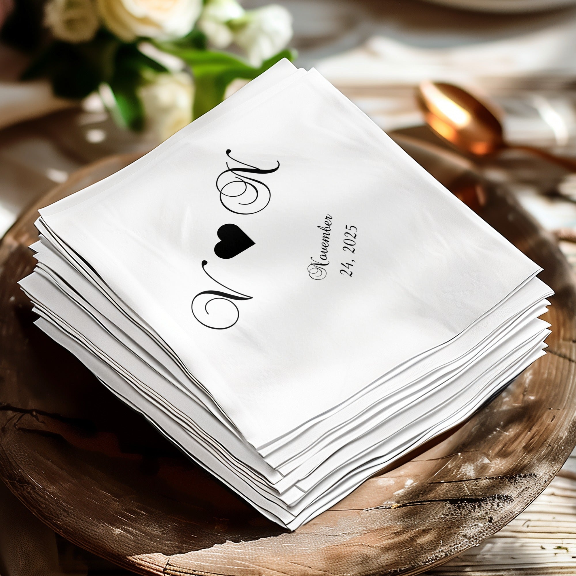 White cocktail napkins with black initials and date: "N M" and "November 24, 2025".
