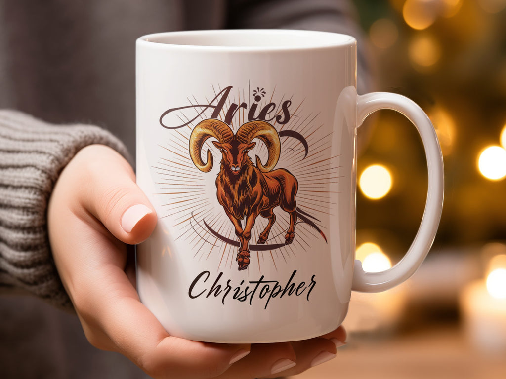 Mug with Aries ram symbol and "Christopher" text, held by a person.