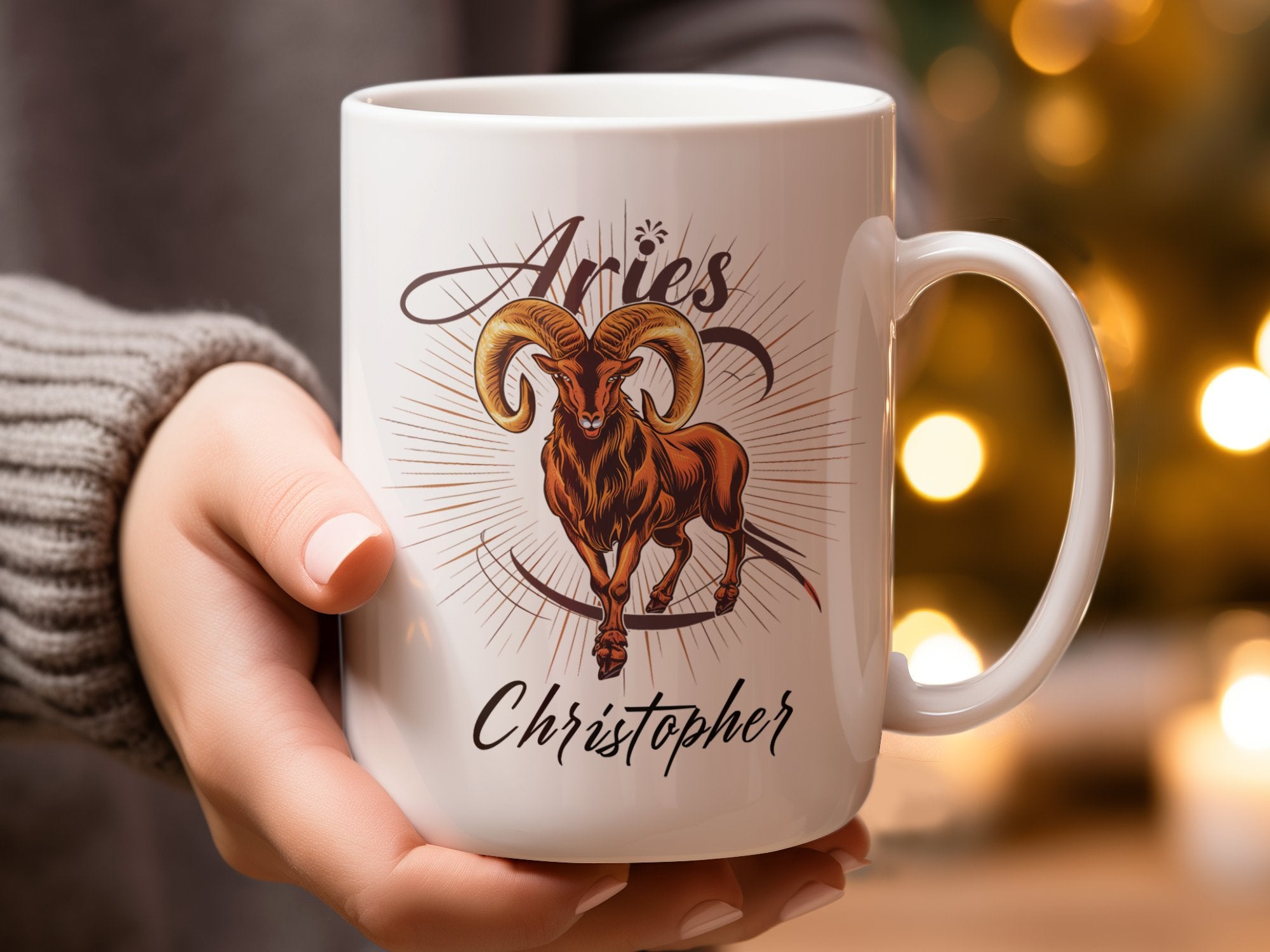 Mug with Aries ram symbol and "Christopher" text, held by a person.