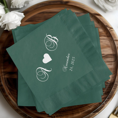 Dark green napkins with white "A & B" monogram and "November 24, 2025" text.