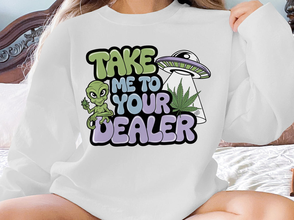White sweatshirt with "TAKE ME TO YOUR DEALER" graphic featuring alien and UFO.