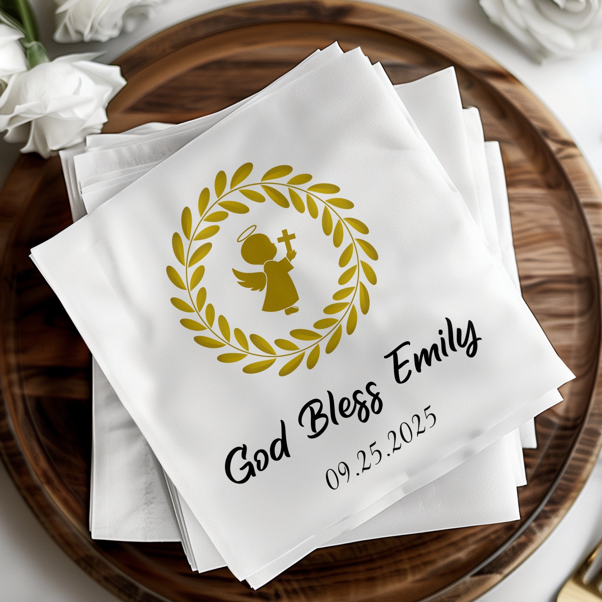 Gold angel and wreath design with "God Bless Emily 09.25.2025" on white napkins.