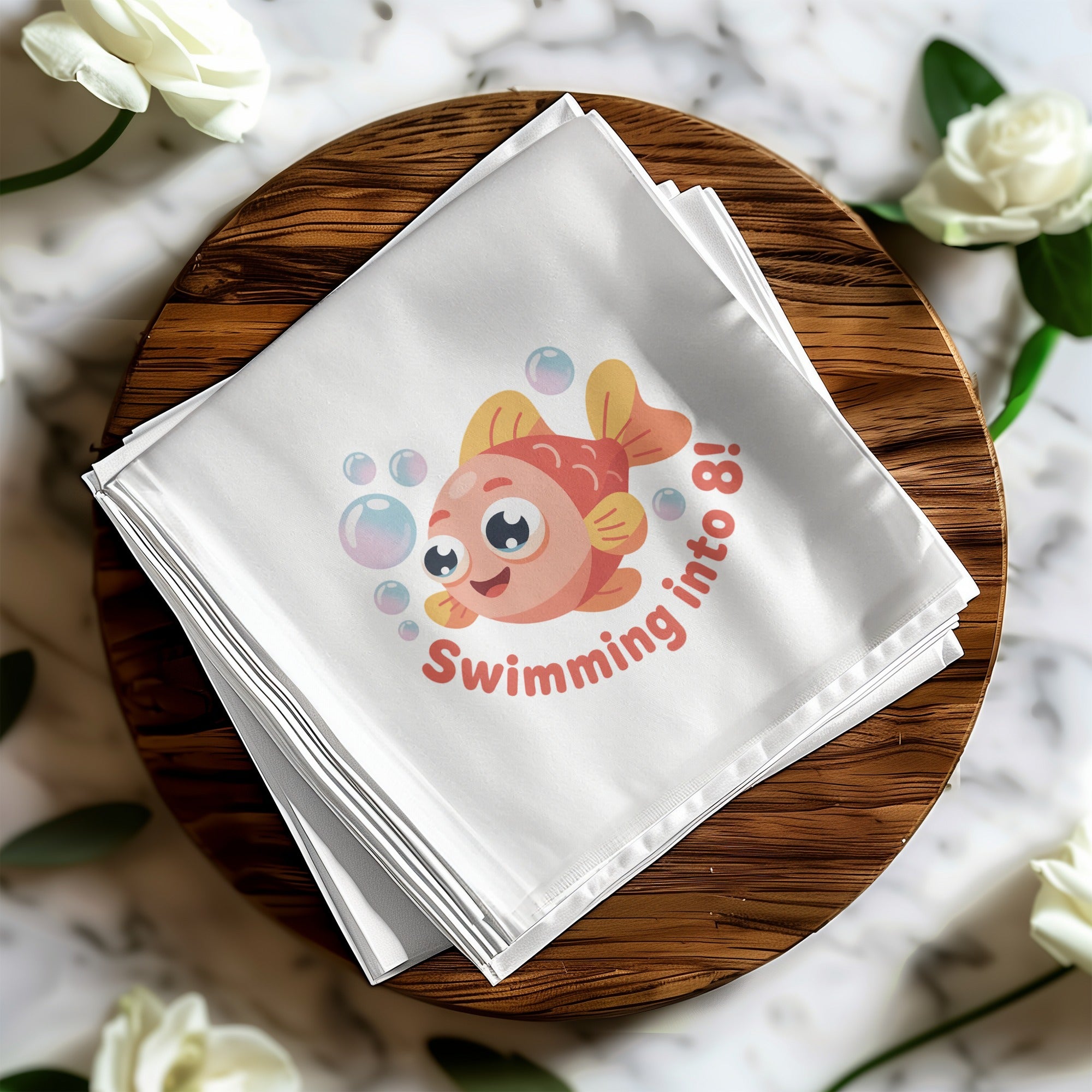 Pink cartoon fish with "Swimming into 8!" text on a white cloth.