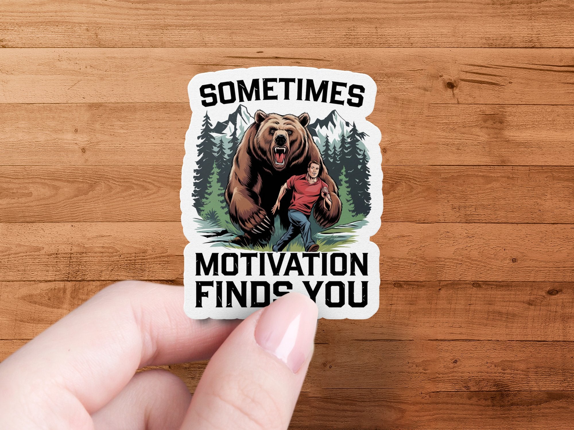 Sticker of a man running from a bear with text "SOMETIMES MOTIVATION FINDS YOU".