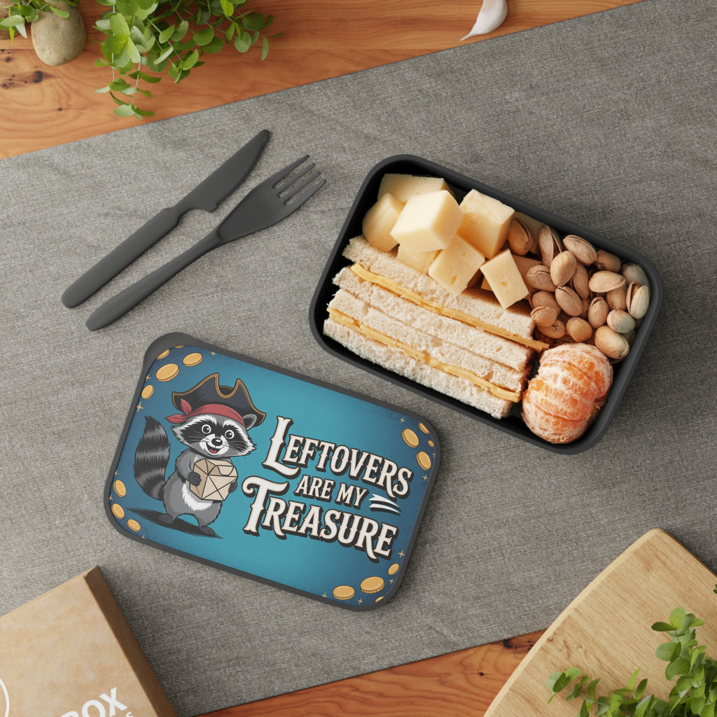 Lunchbox with raccoon pirate and sandwich, nuts, and tangerines.