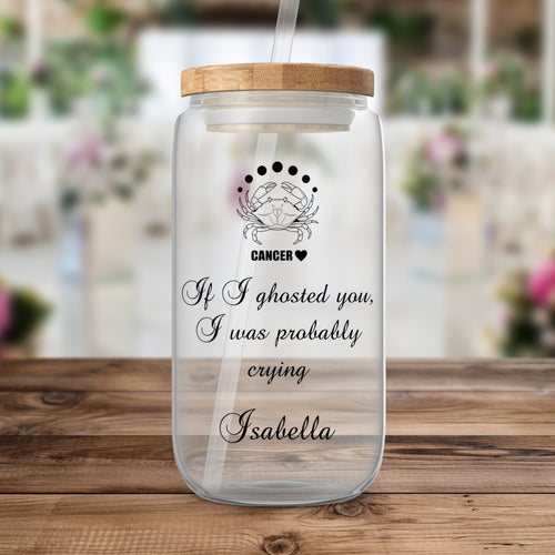 Glass tumbler with straw, featuring Cancer zodiac symbol and text.