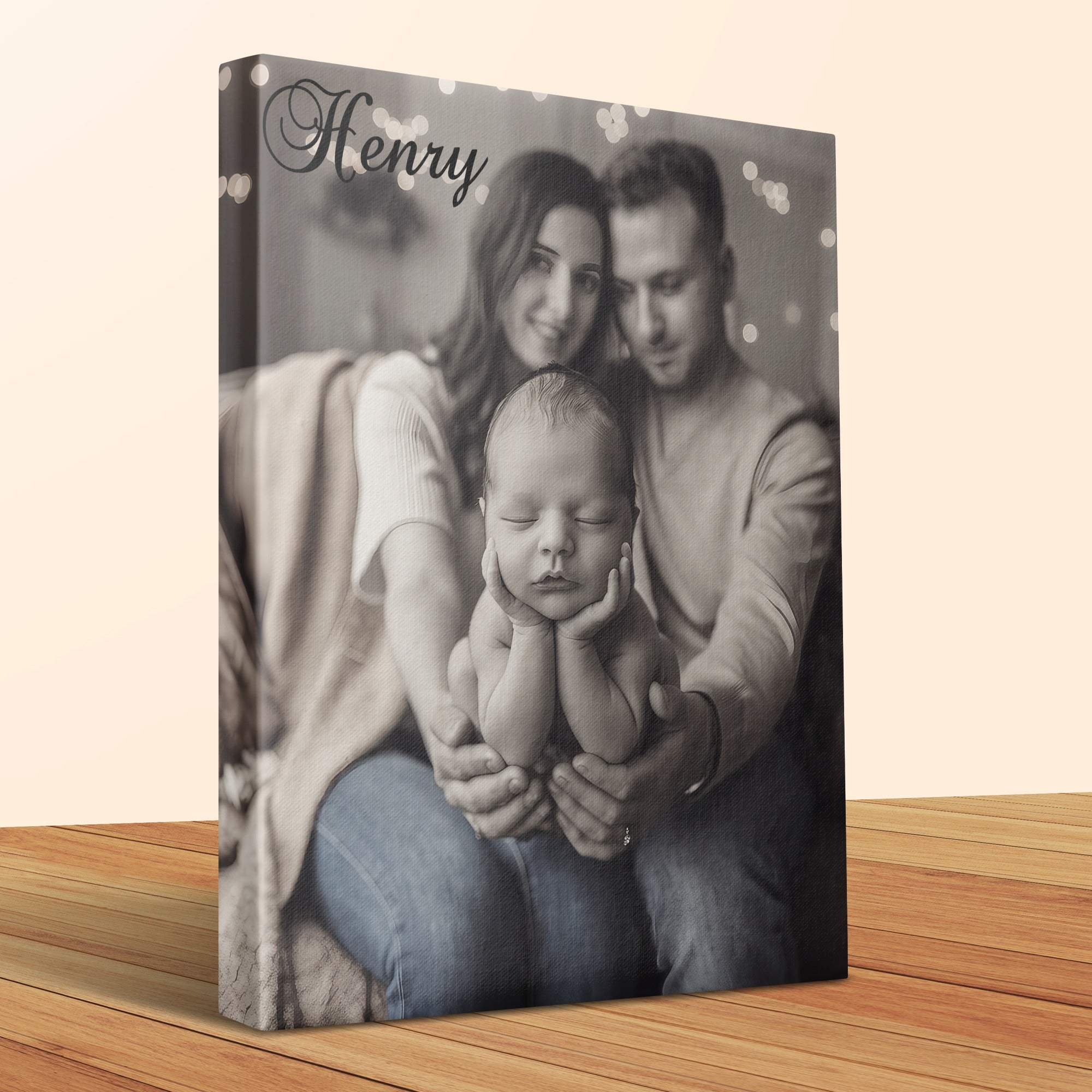 Canvas print of parents holding newborn baby with "Henry" text.
