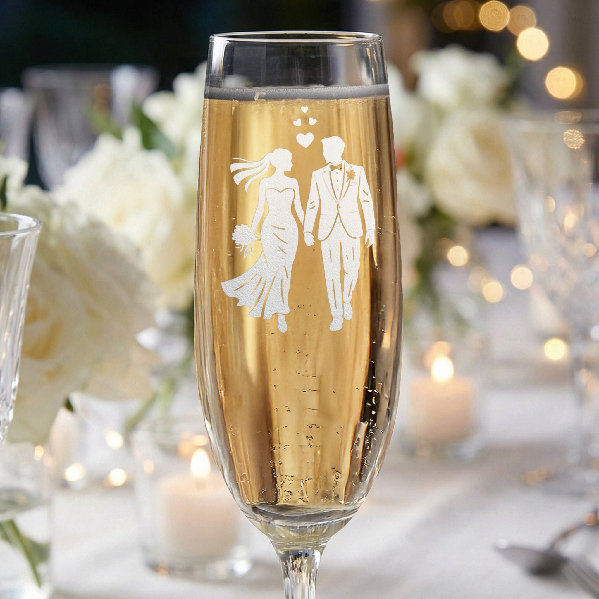 Champagne flute with etched silhouette of bride and groom for wedding.