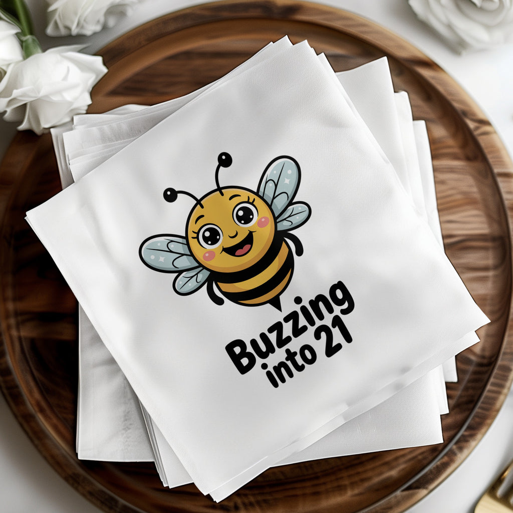 White cocktail napkins with a cartoon bee and "Buzzing into 21" text.