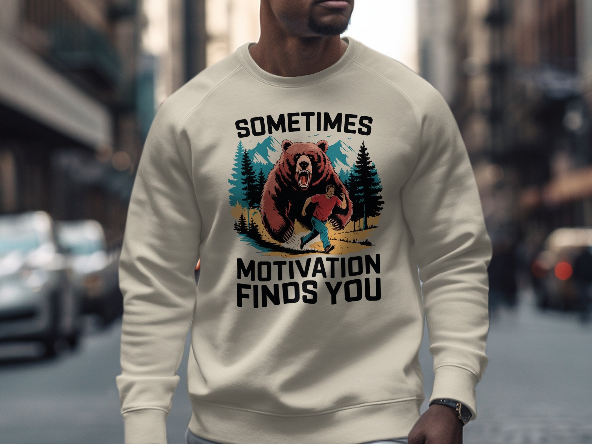 Crewneck sweatshirt with a graphic of a person running from a bear in a mountain landscape.