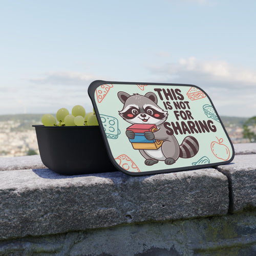 Raccoon character holding books on lunchbox lid with text "THIS IS NOT FOR SHARING."