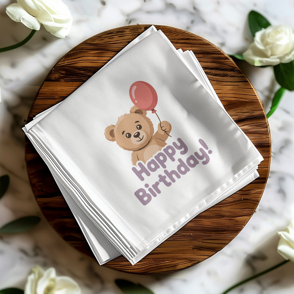 White napkin with teddy bear holding balloon and "Happy Birthday" text.