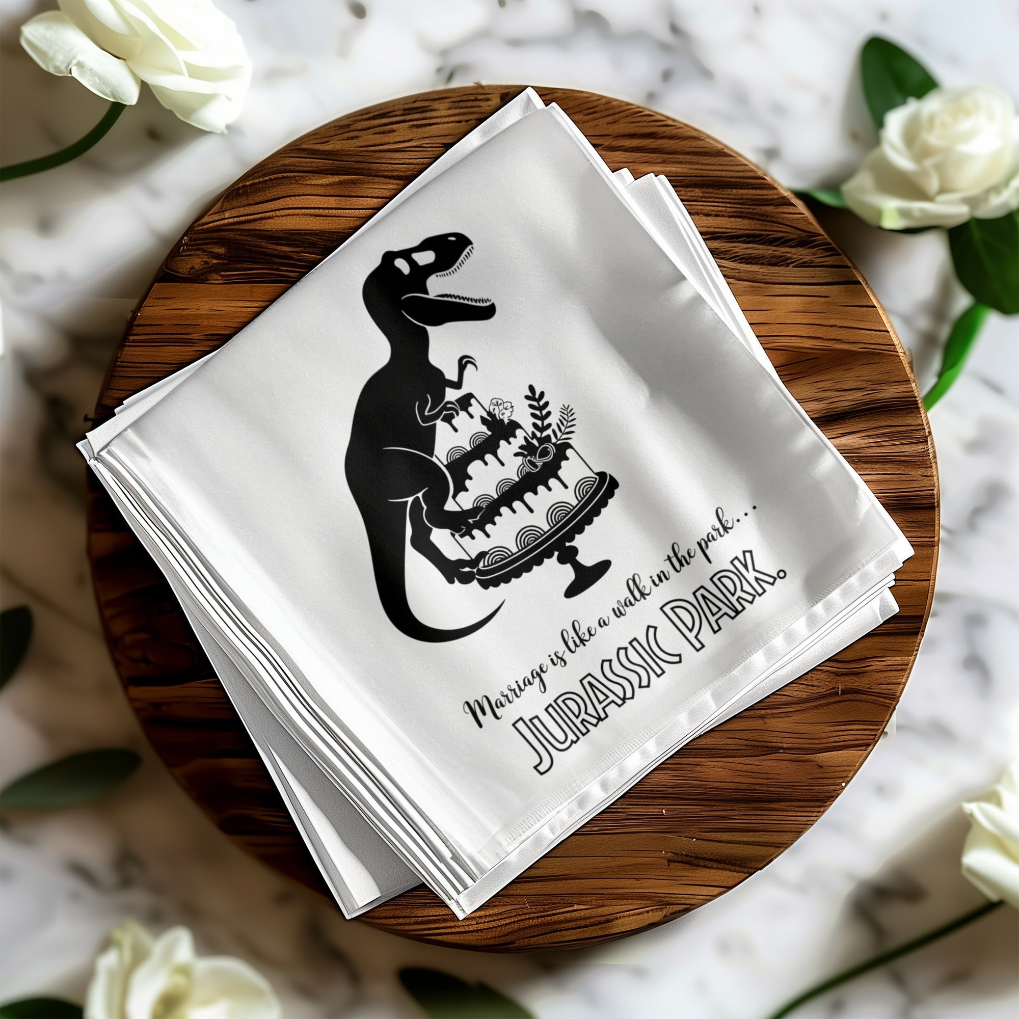 Black dinosaur silhouette on wedding cake with text "Marriage is like a walk in the park... Jurassic Park".