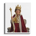Child in a king costume with crown and scepter sits on a throne.