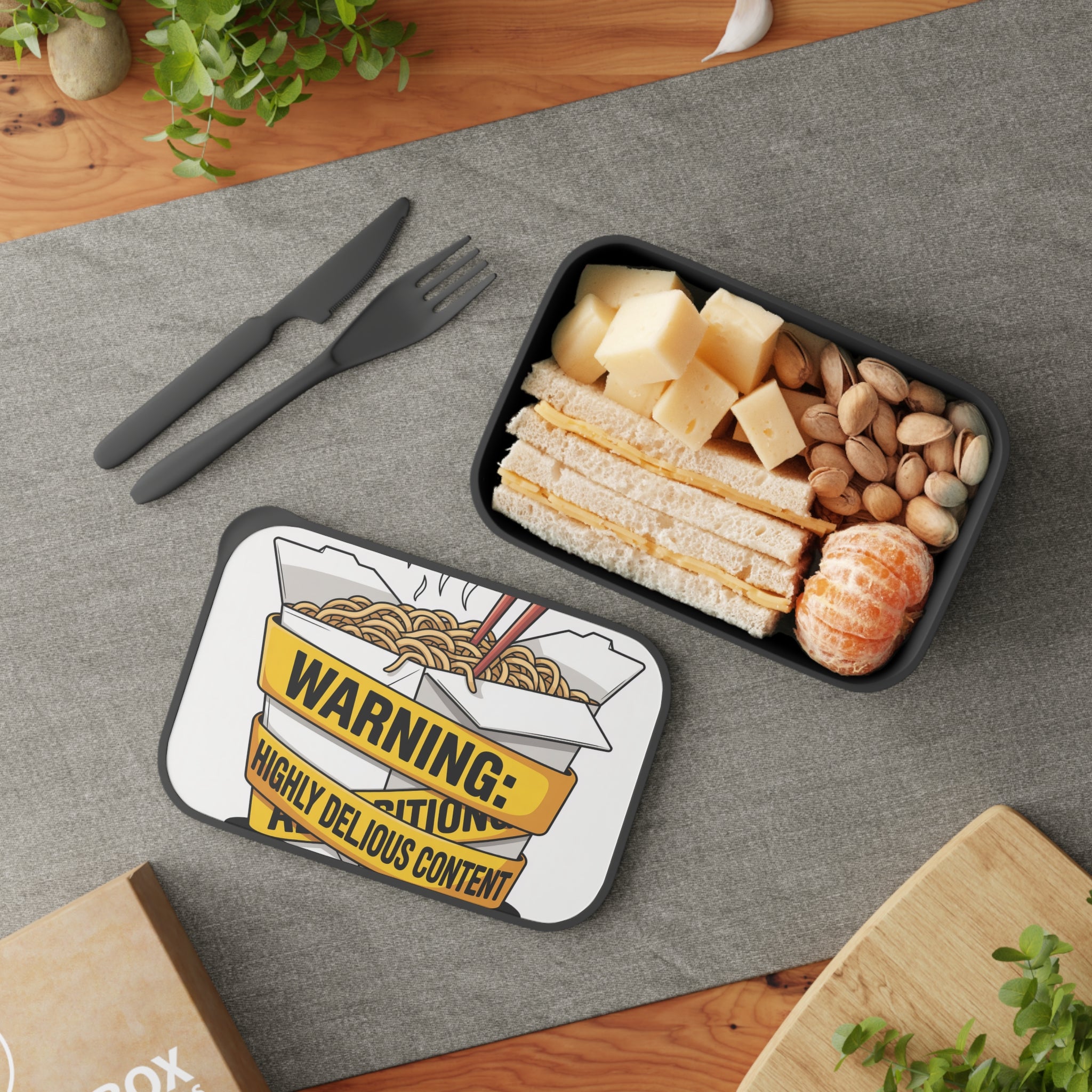 Lunchbox with noodles and sandwich, plus cheese and pistachios.