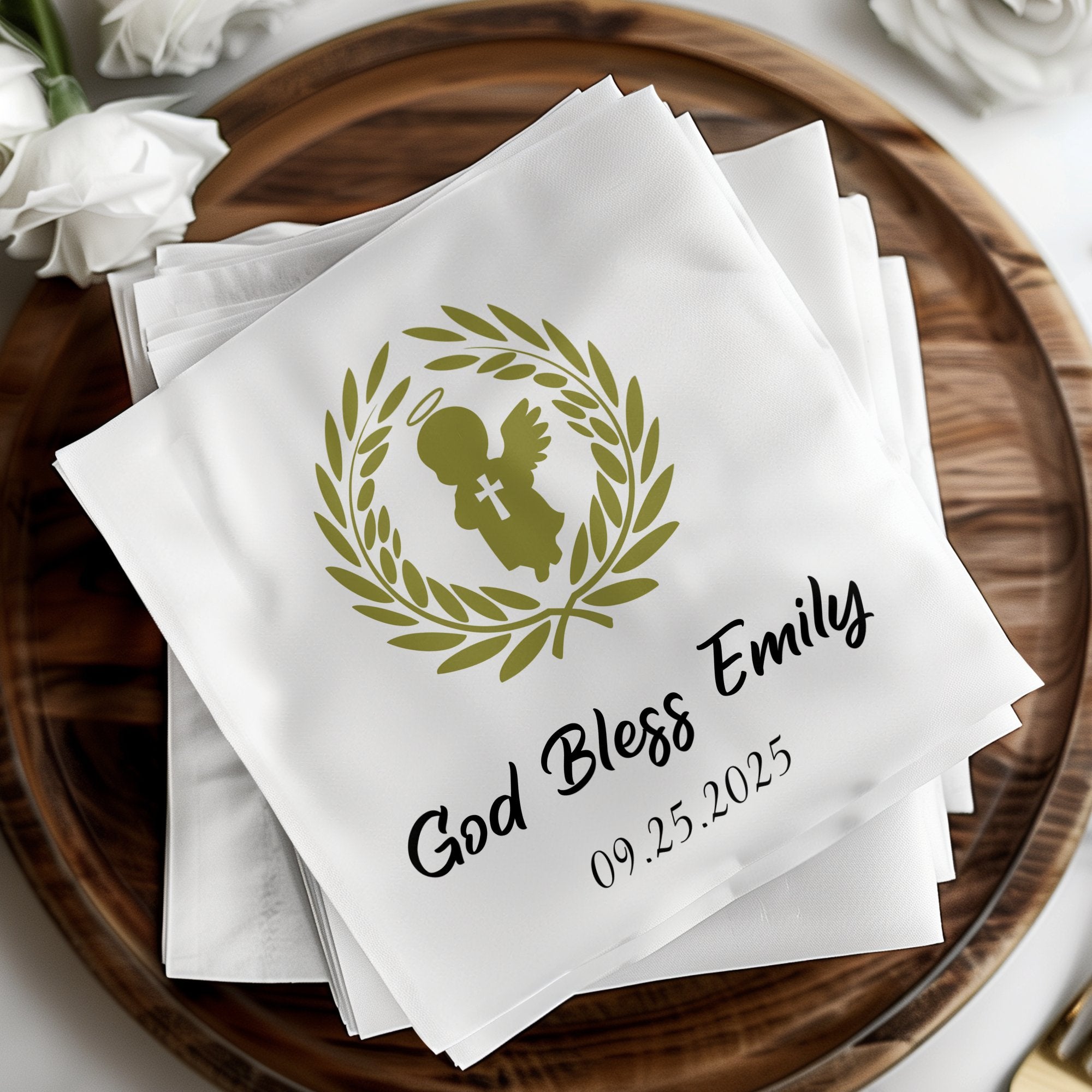 White napkin with "God Bless Emily" and a winged figure.