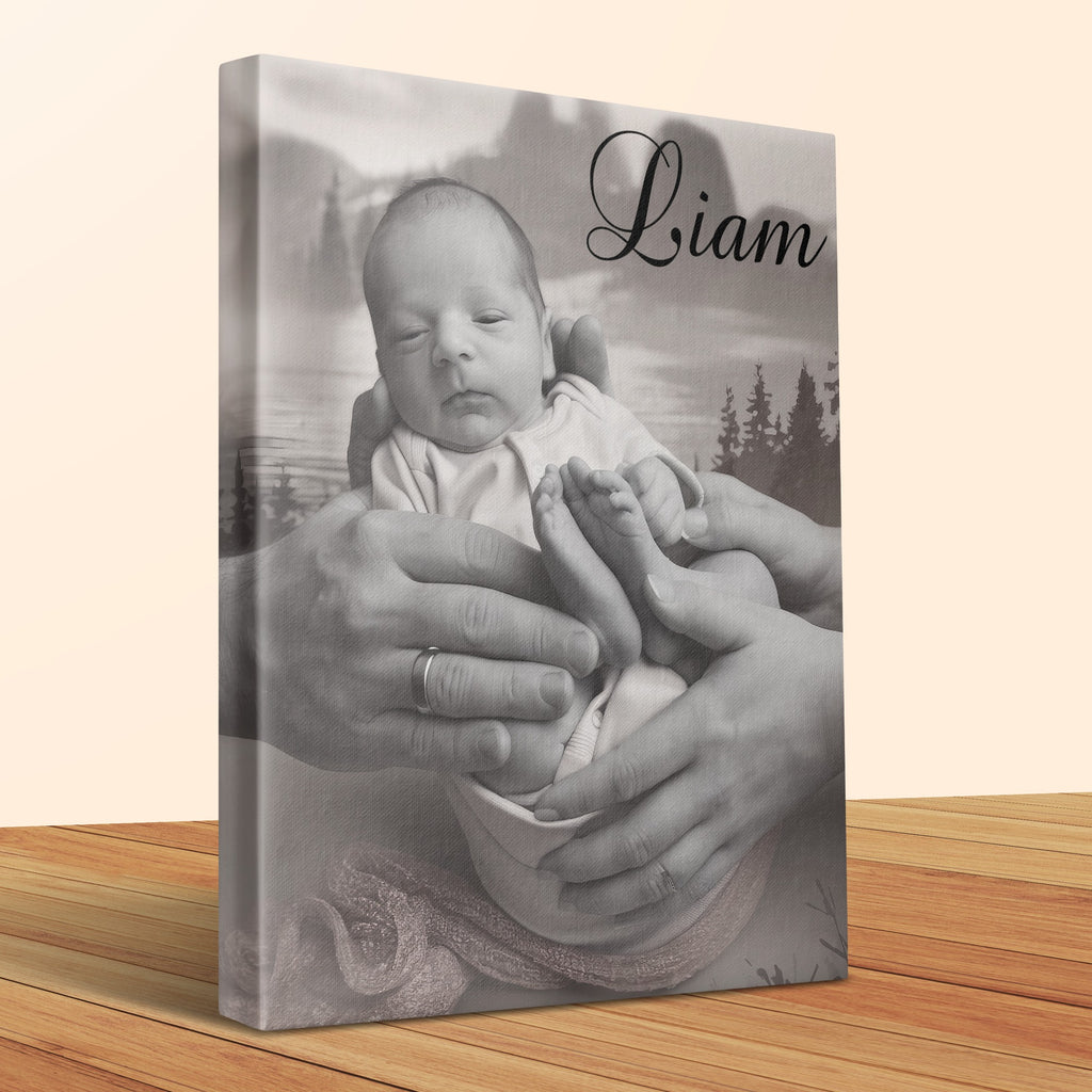 Canvas print of baby Liam held by adult hands with a mountain landscape.