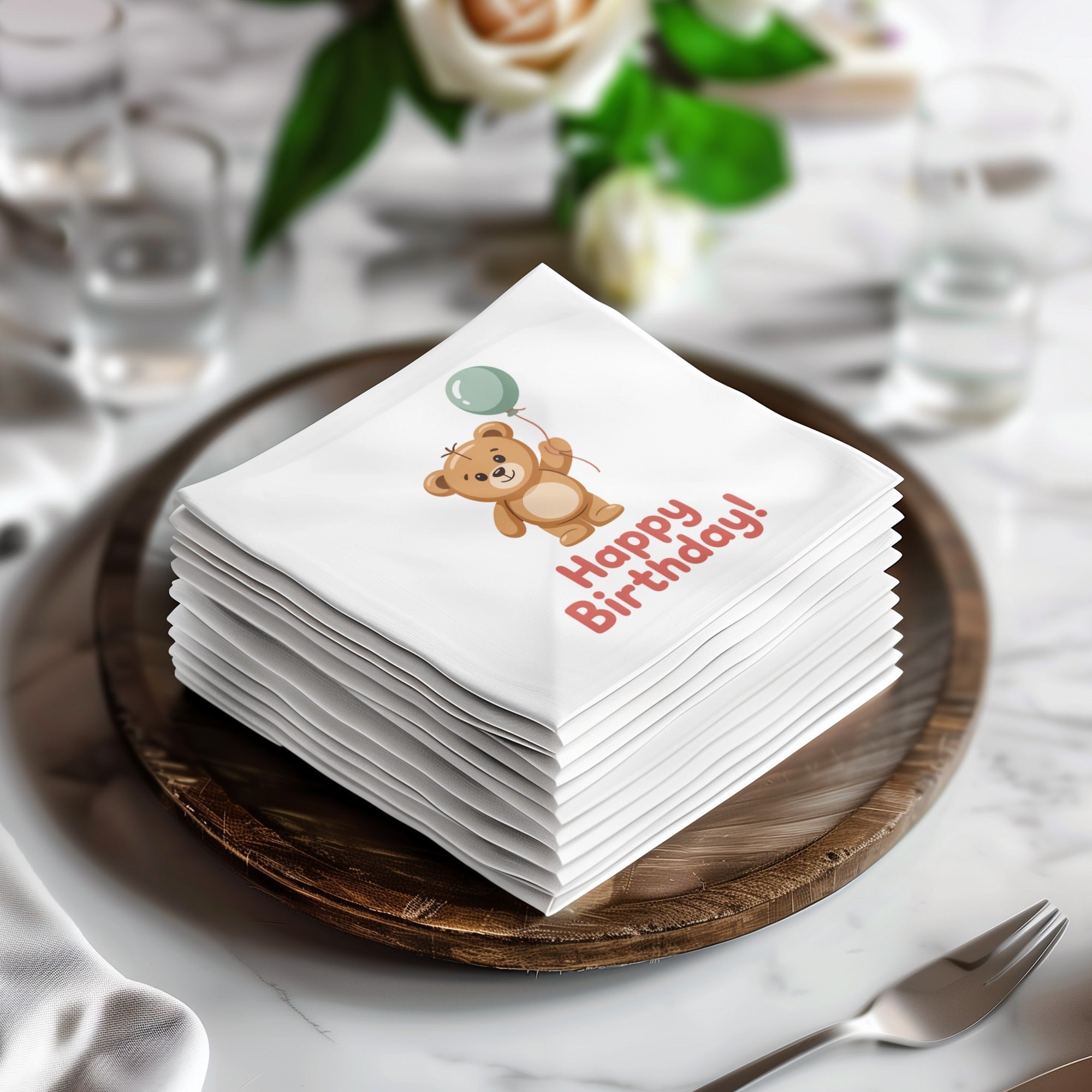 Stack of napkins with a teddy bear holding a balloon and "Happy Birthday!" text.