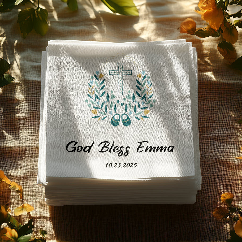 Stack of white napkins with "God Bless Emma" and a cross wreath.