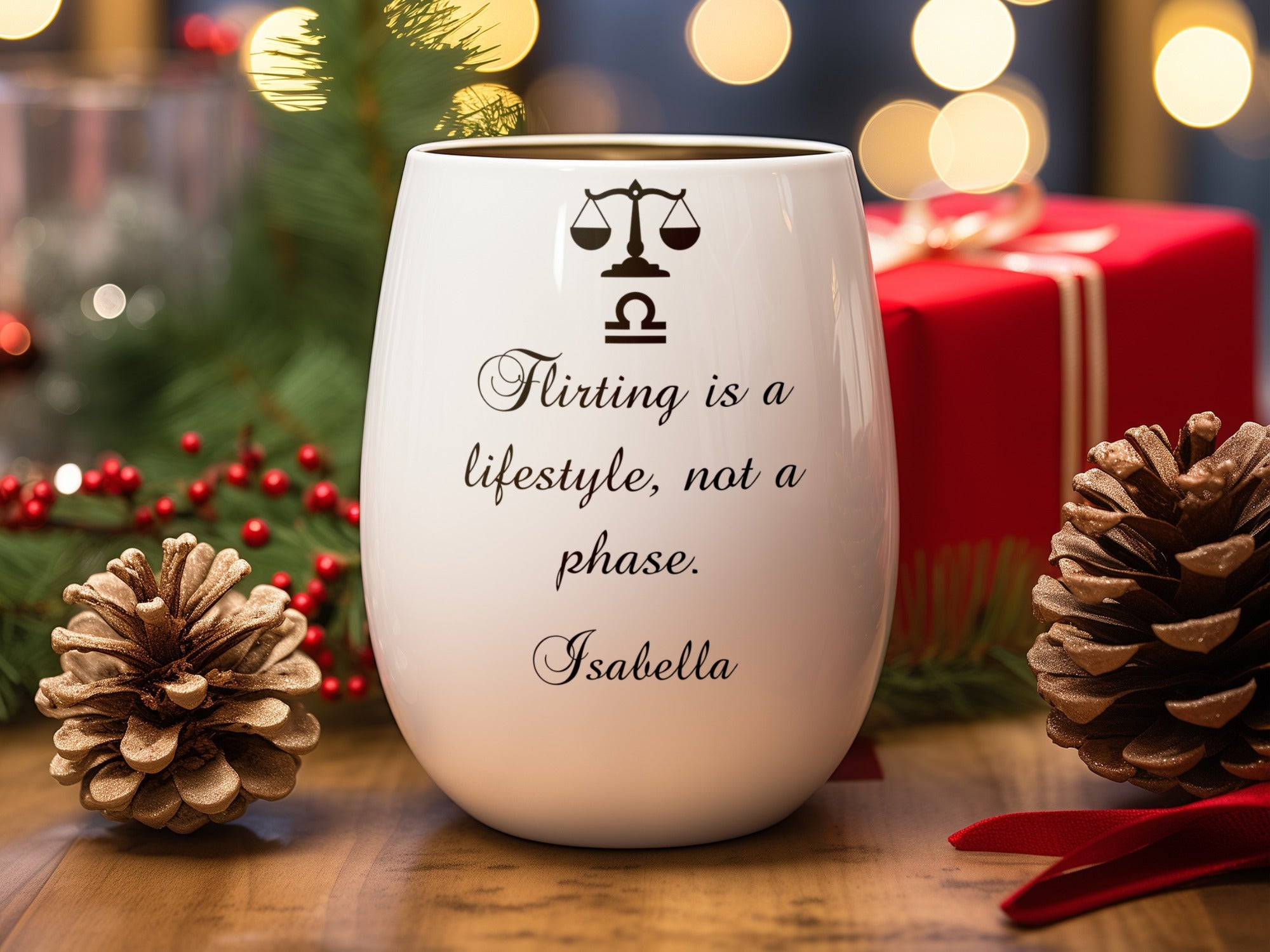 White wine glass with Libra symbol and quote, surrounded by holiday decorations.