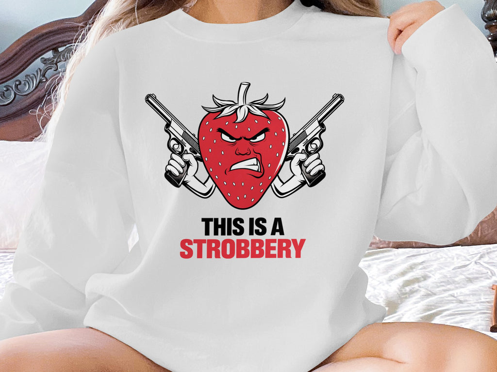 White sweatshirt with angry strawberry holding two guns and text "This is a Strobbery".