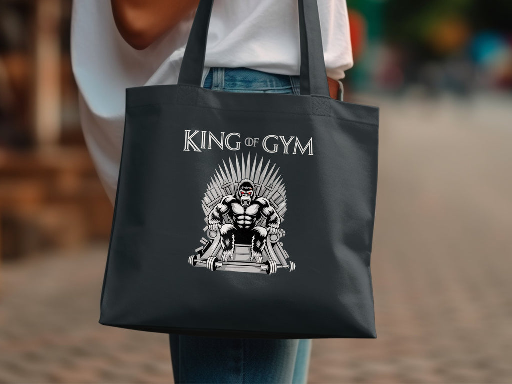 Dark tote bag with King of Gym gorilla on throne design.