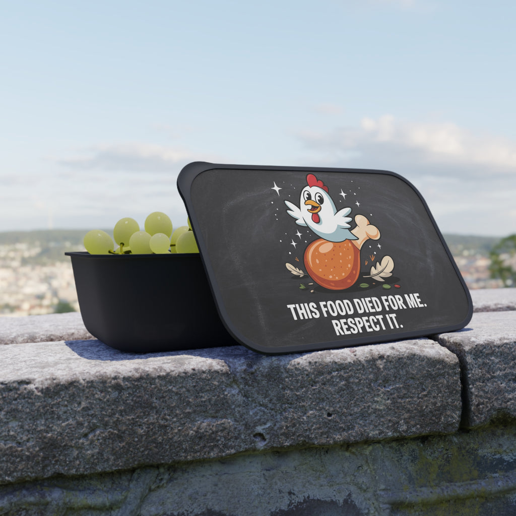 Black lunchbox with a chicken drumstick graphic and text: "This food died for me. Respect it."