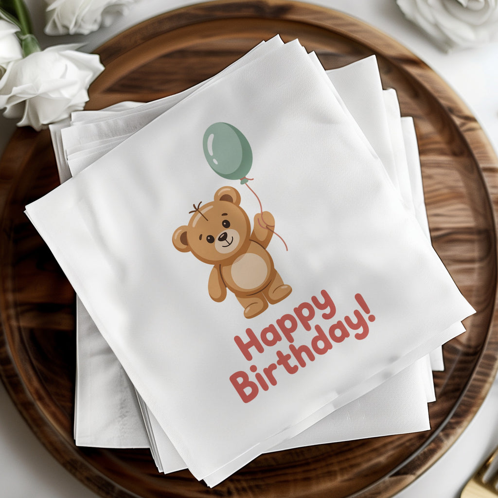 White napkin with a teddy bear holding a balloon and "Happy Birthday!" text.