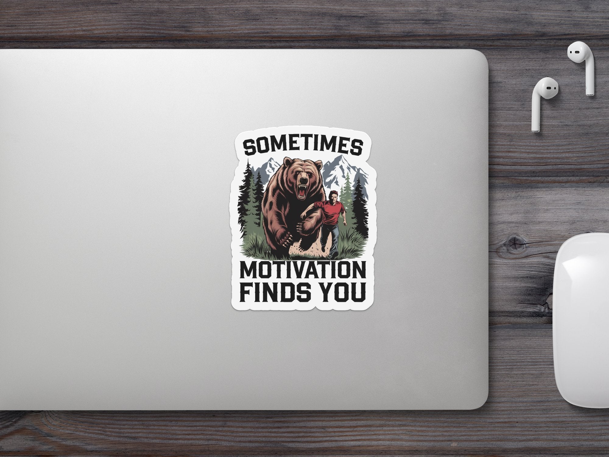 Bear and man with text "SOMETIMES MOTIVATION FINDS YOU" on laptop.