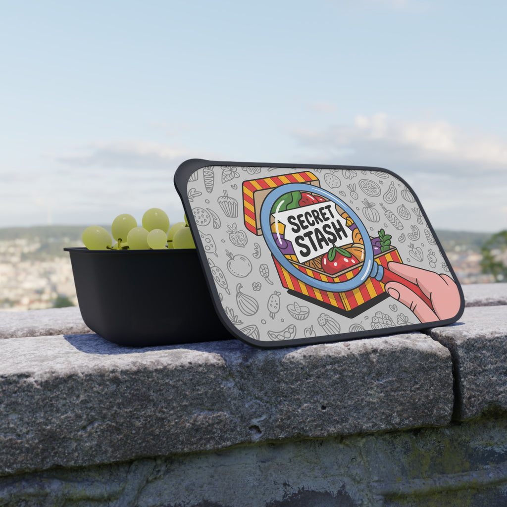Lunchbox with "Secret Stash" lid featuring fruits and vegetables.