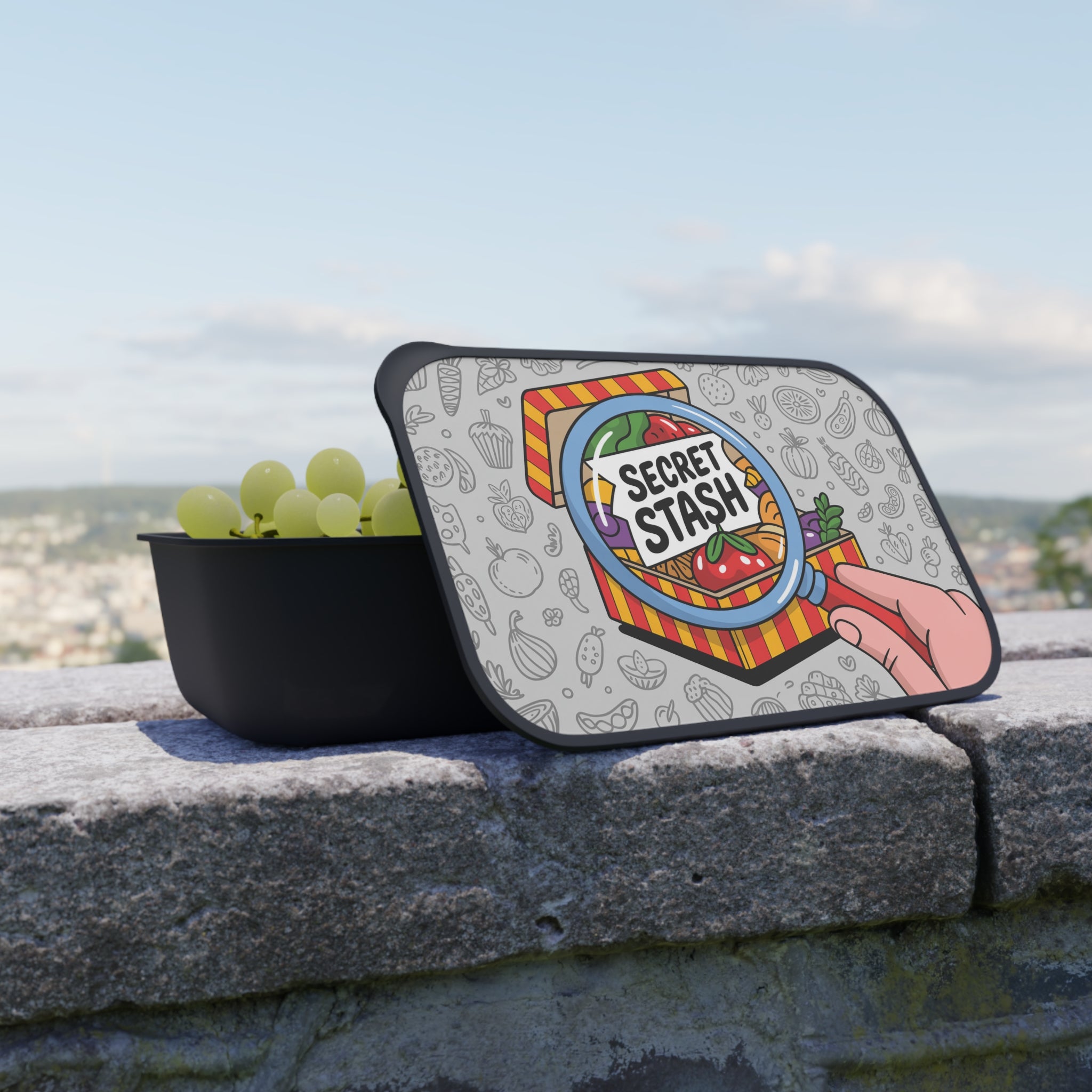 Lunchbox with "Secret Stash" lid featuring fruits and vegetables.