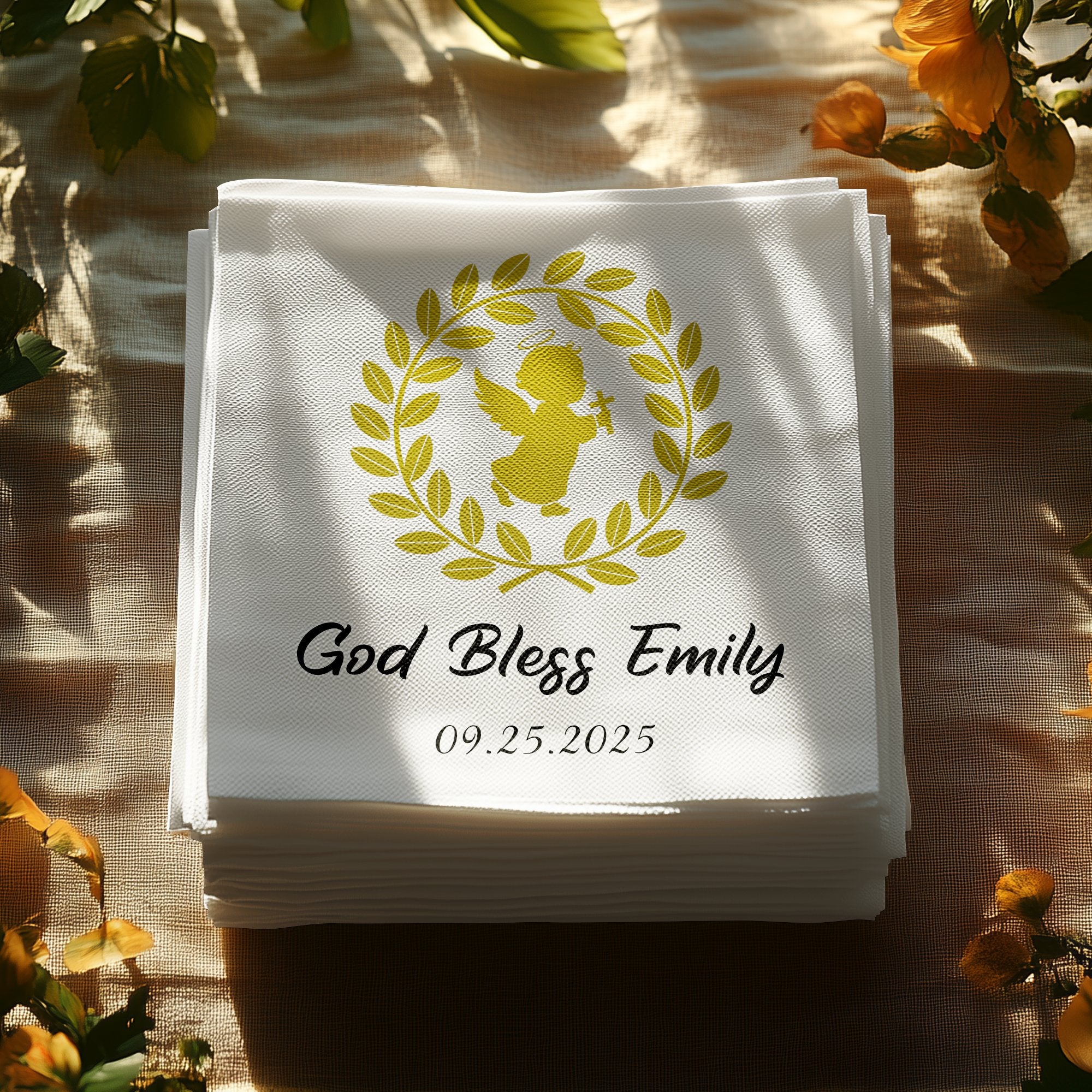 White napkins with "God Bless Emily" and a date, featuring a golden angel design.
