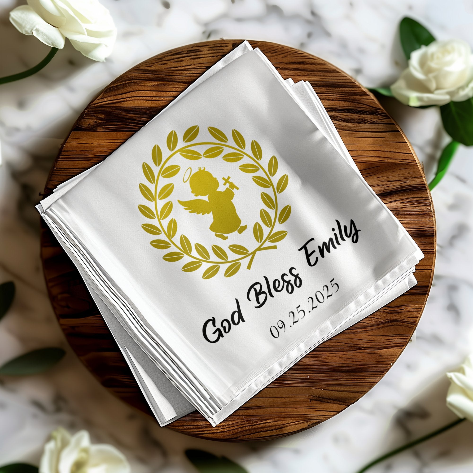 White cloth with gold angel, wreath, "God Bless Emily", and date.