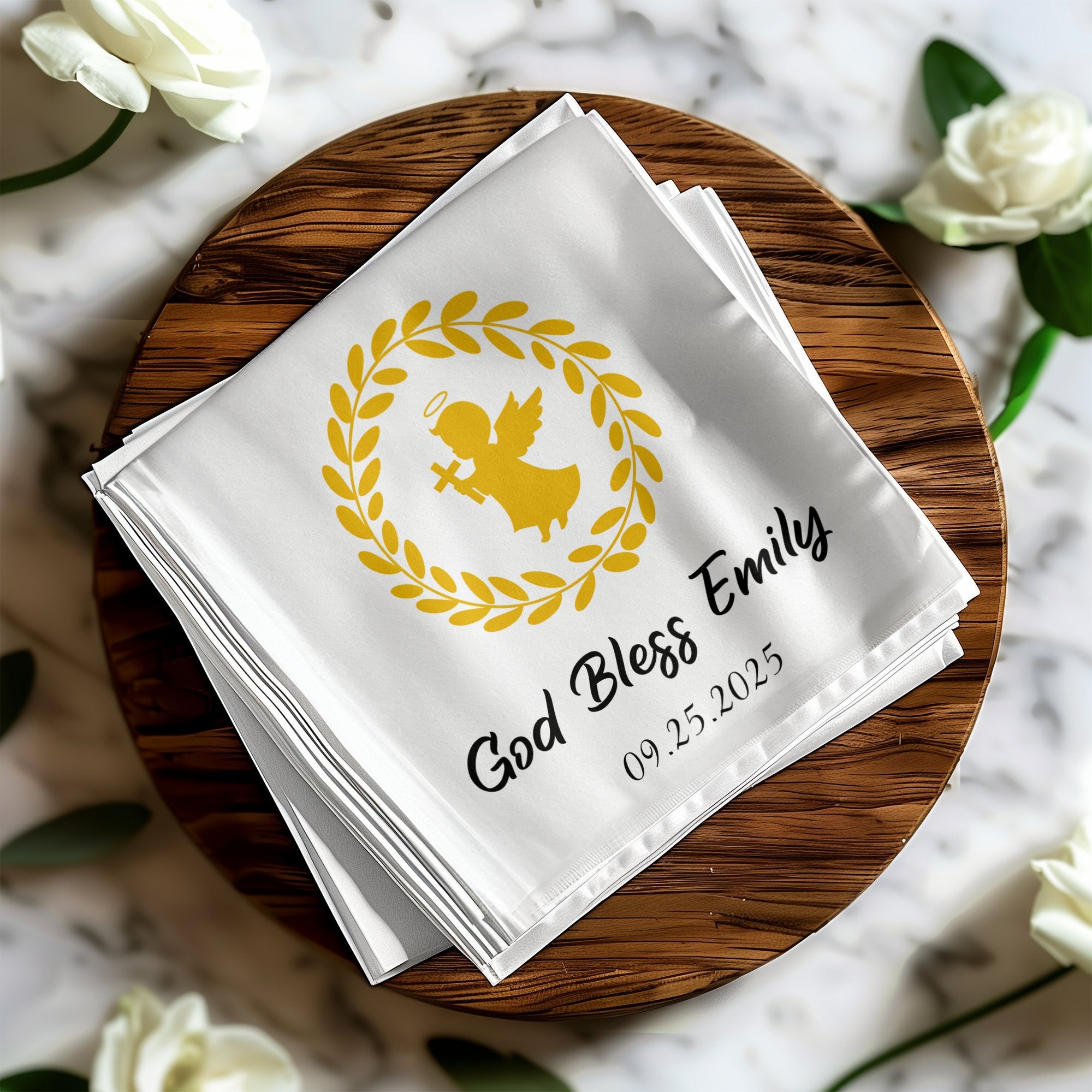 White linen napkins with gold angel and wreath, "God Bless Emily 09.25.2025".