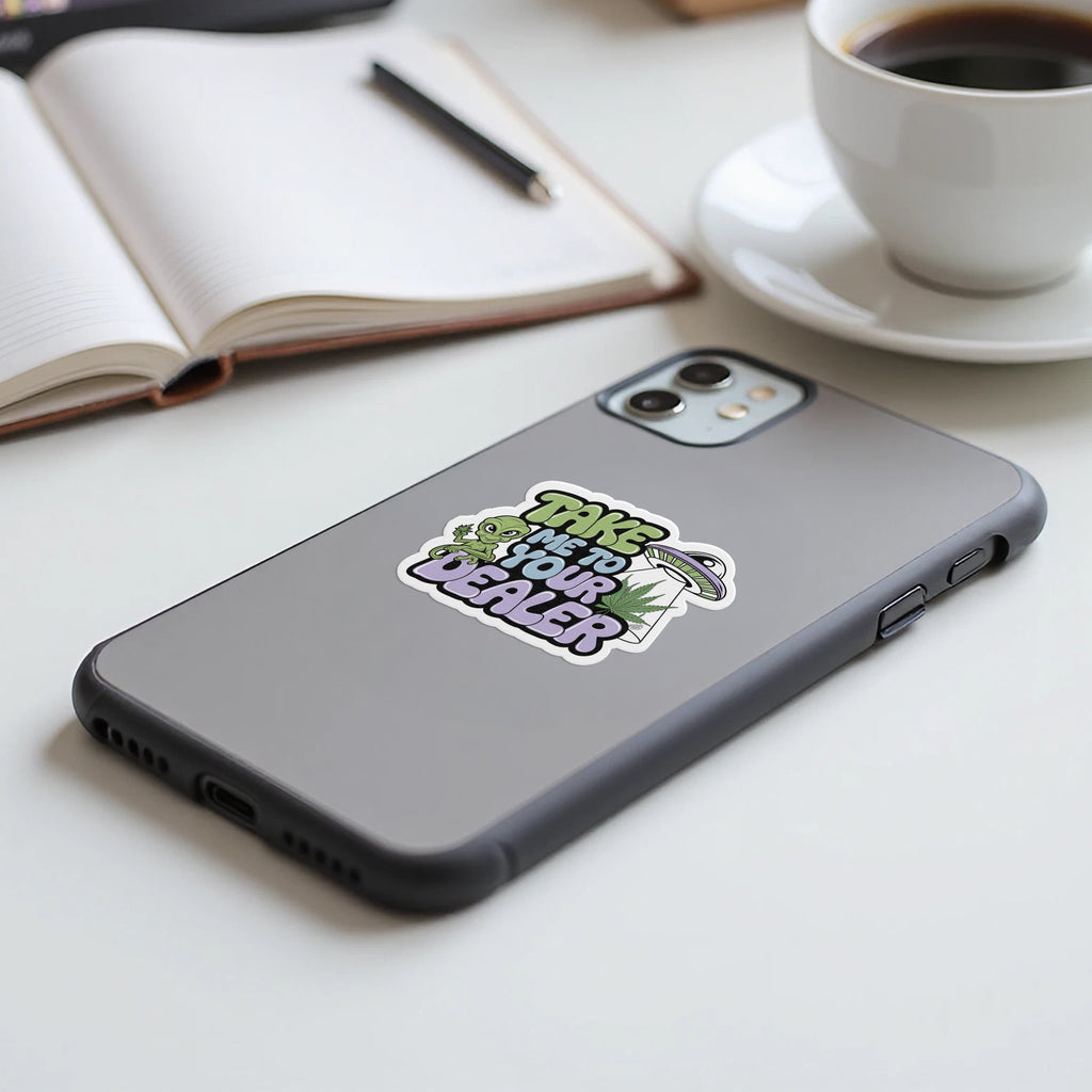 Sticker with "Take me to your dealer" text and alien on phone.