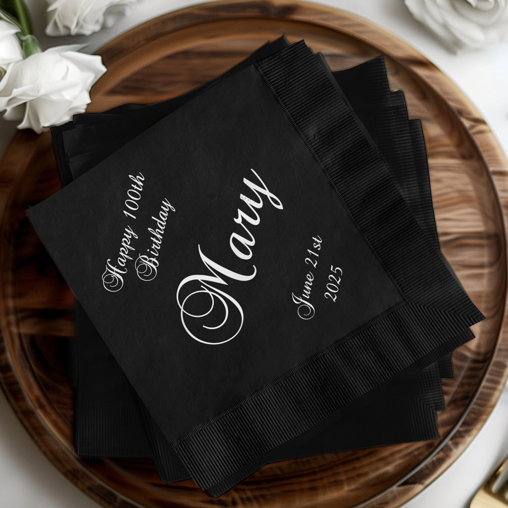 Black cocktail napkins with "Happy 100th Birthday Mary June 21st 2025" text.