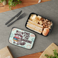 Lunchbox with raccoon illustration and sandwich, cheese, and nuts inside.