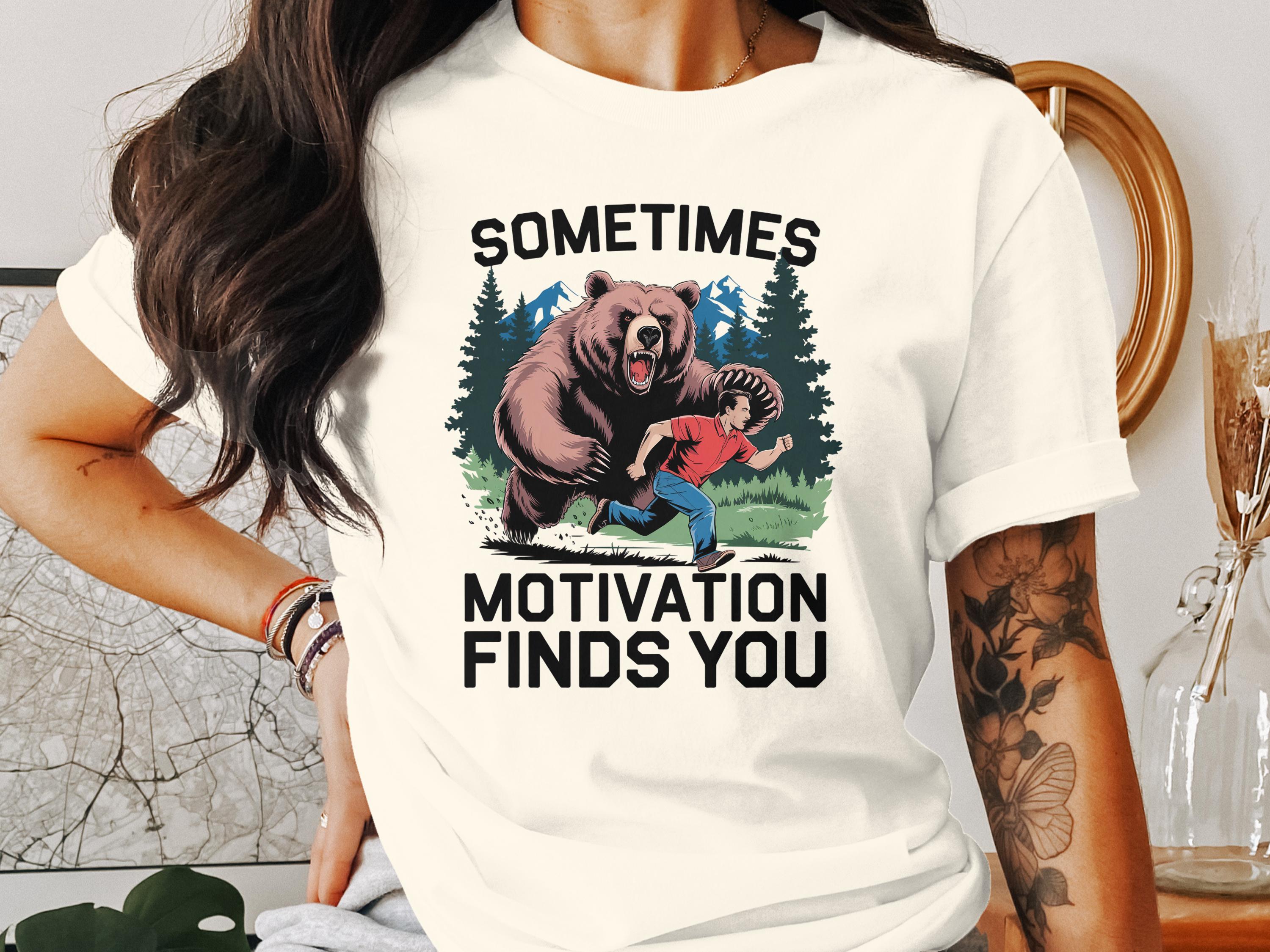 Bear chasing a person in a forest with text "Sometimes Motivation Finds You".
