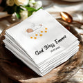 White napkin with "God Bless Emma" and date 10.23.2025, featuring an angel and stars.
