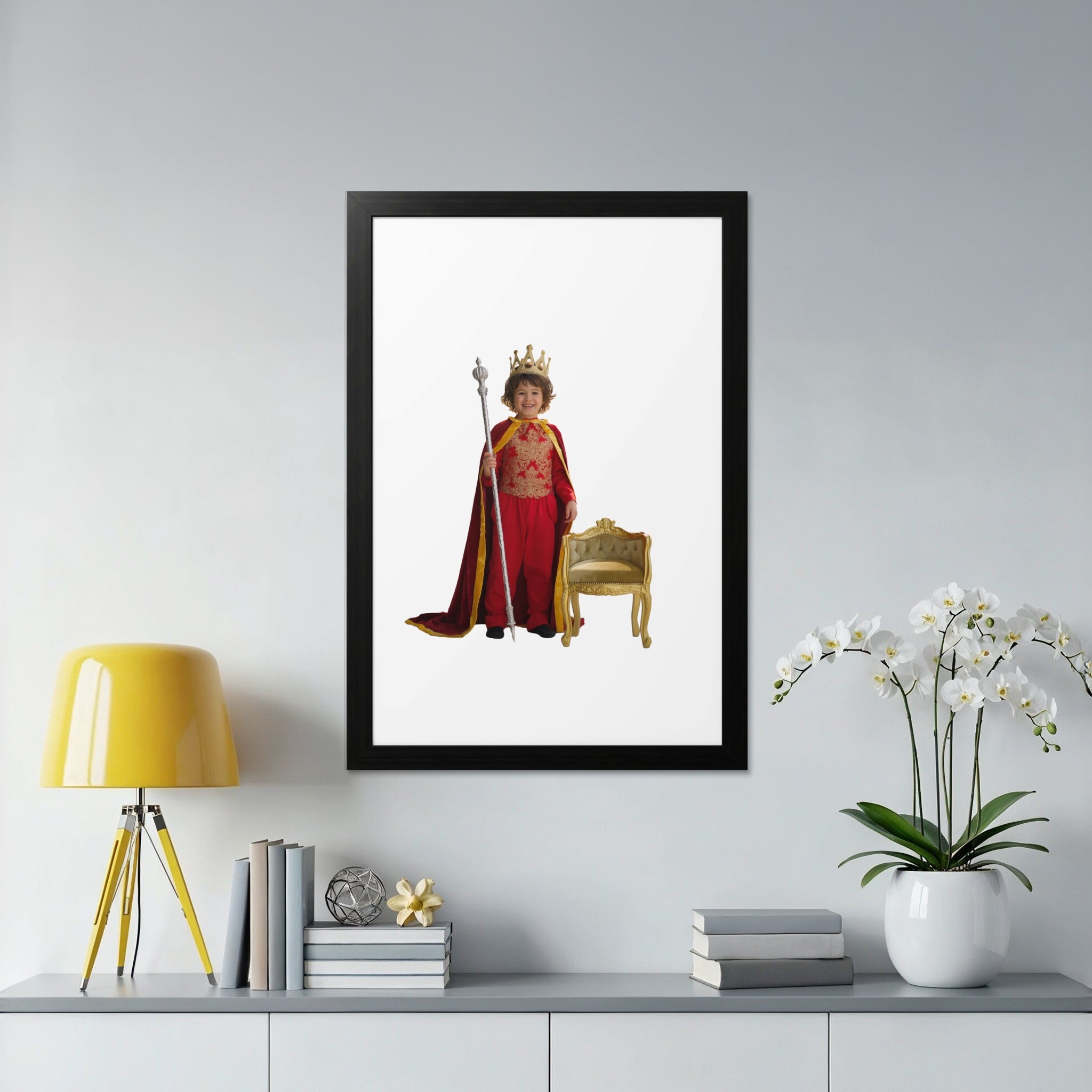 Child in king's costume stands by ornate gold chair with scepter.