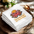 Smiling octopus with text "Tentacle Hugs for my birthday!" on a stack of napkins.