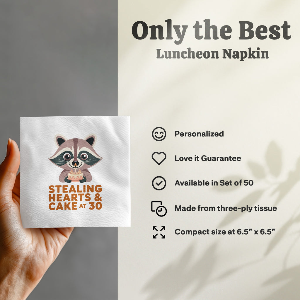 Napkin with raccoon holding cake, reads "Stealing Hearts & Cake at 30."